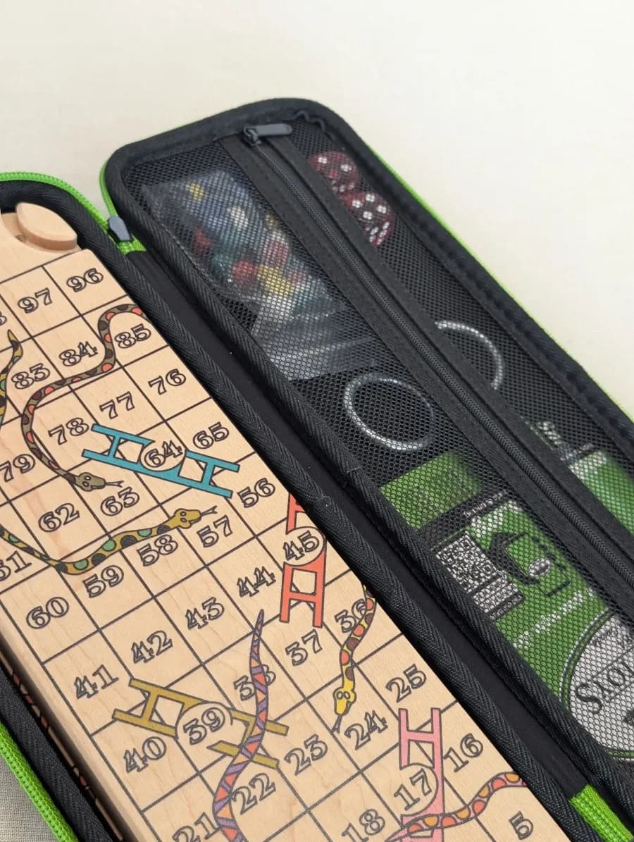 Wooden travel Snakes and Ladders board and game pieces in a zippered case