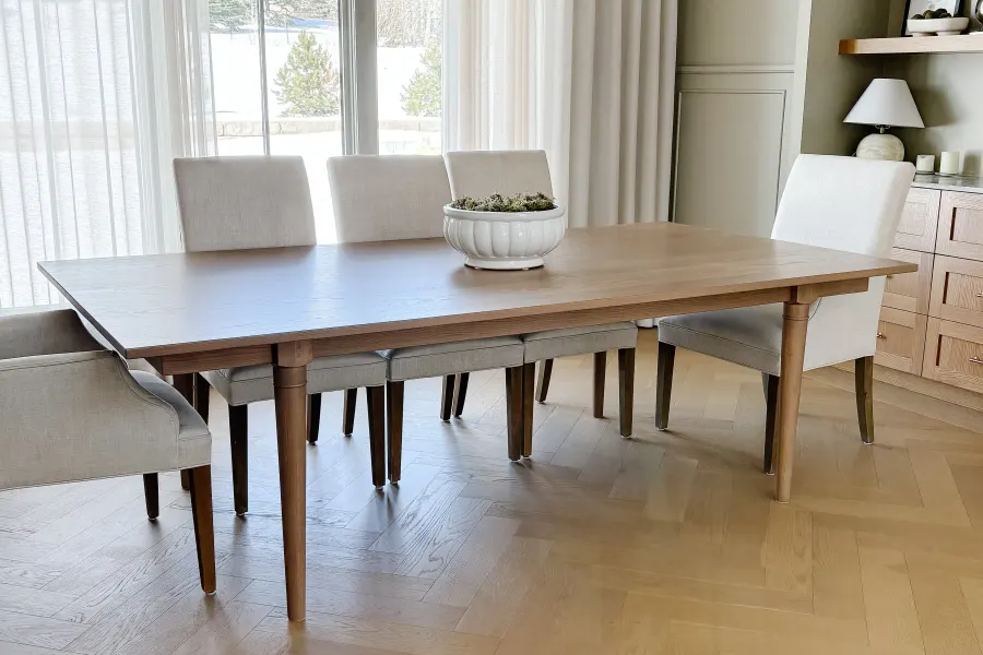 Avenly solid-wood dining table surrounded by upholstered chairs