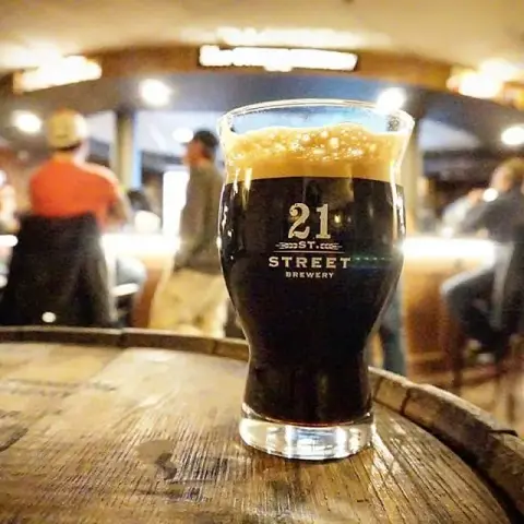 A dark beer in a 21st Street Brewery glass