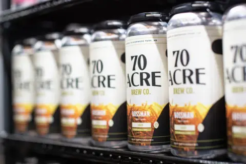 Cans of 70 Acre beer lined up in a cooler