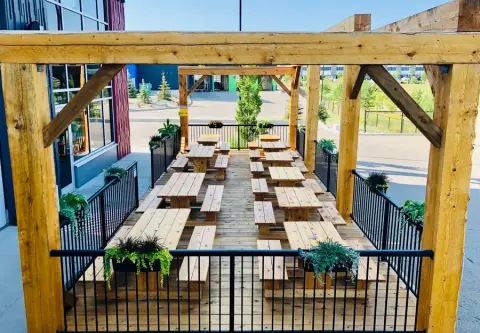 The 70 Acre patio with long wooden tables