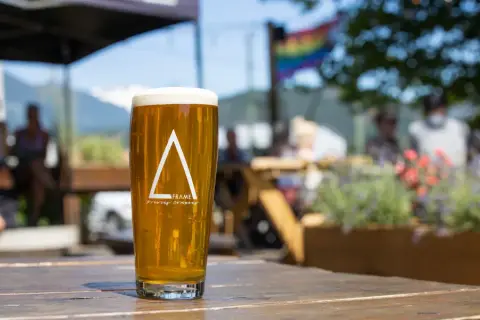 A pint of A-FRAME beer on the patio