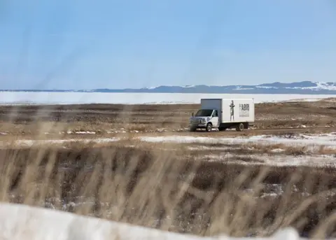 An À l'abri de la Tempête delivery truck crossing the Îles de la Madeleine