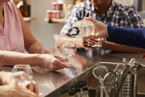 A spirit being poured into a tasting glass at the Apikol bar