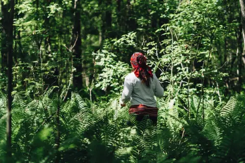 Cree-Métis guide Michela Carriere standing in the forest of the Saskatchewan River Delta, leading Indigenous eco-tourism and holistic advent