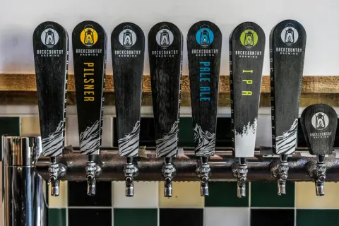 Backcountry Brewing tap handles for its pilsner, pale ale and IPA