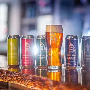 Backroads Brewing cans beside a glass of beer