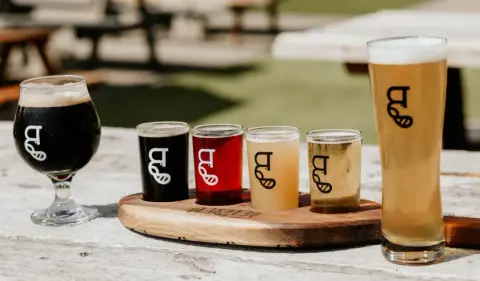 A flight of Big Beaver beers on a patio table