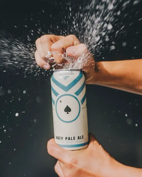 Can of BNA ACE hazy pale ale being opened