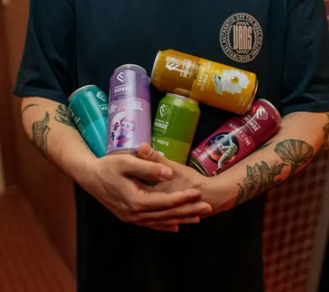 A range of Brasseurs du Monde beer cans