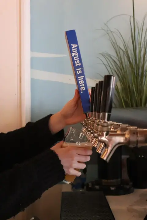 Row of beer taps at the Brewing August bar