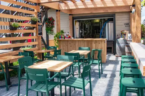 Camp de Base terrace bar with cans on the counter and the brewhouse behind