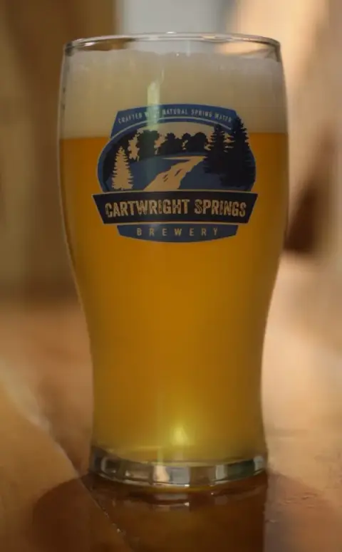 A pint of Cartwright Springs beer in a branded glass