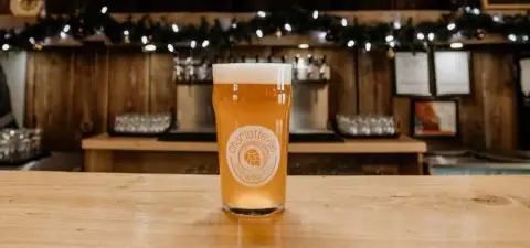 A pint of Charlotteville beer on the tap house bar