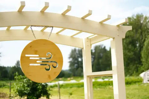 Cold Front Cider sign hanging from a wooden arbour at the farm