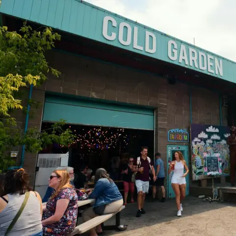 Cold Garden entrance with signage and outdoor seating