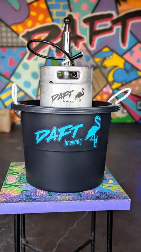 Daft Brewing mini keg with tap in an ice bucket