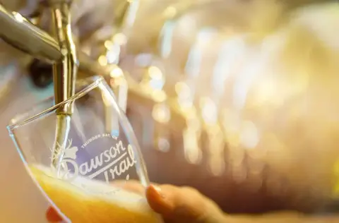 Dawson Trail beer being poured at the brewery
