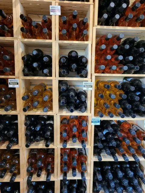 Racks of Our Roots fruit wine bottles in the DNA Gardens farm store