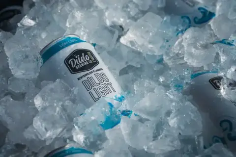 Dildo Light beer cans chilled in a pile of ice