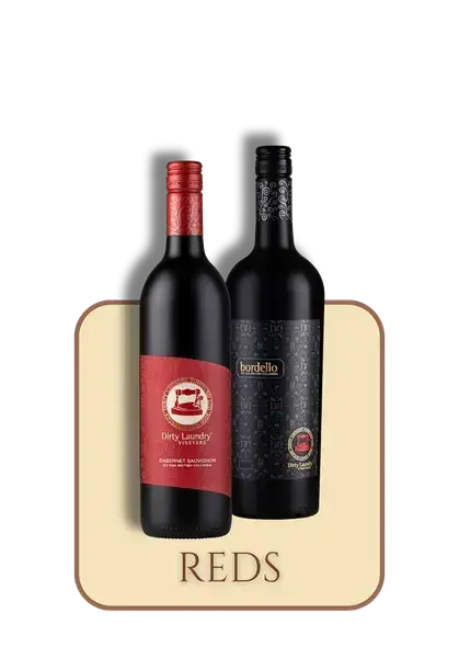 Two bottles of red wine are sitting next to each other on a table.