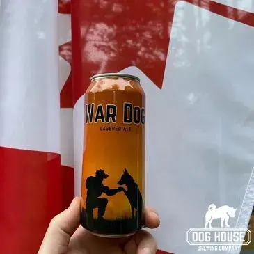 Can of War Dog gold pilsner in front of a Canadian flag