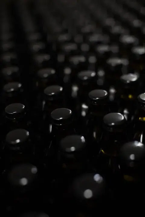 Rows of capped cider bottles in the Domaine RITT cellar