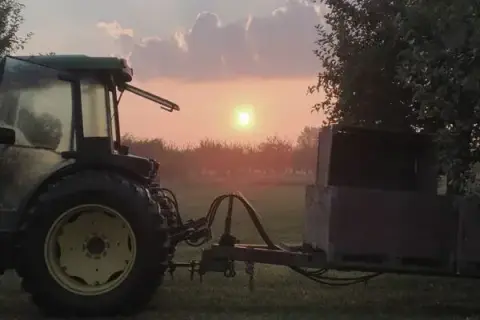 A tractor at sunrise on Dunridge Farms