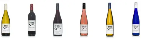 A row of Four Shadows wine bottles