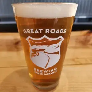 A glass of Great Roads Pop's Pilsner