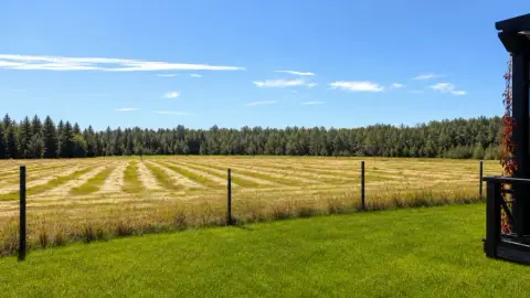 Grey Owl Meadery's hay field and patio in the Alberta foothills