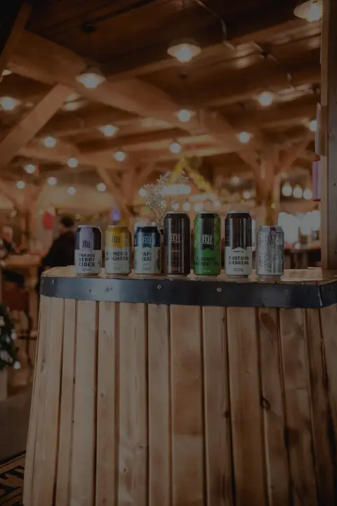 A row of Half Hitch beer cans on a barrel