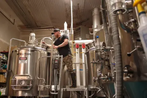 Head brewer mashing in a batch in the Kettle River brewhouse in Kelowna