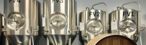 Fermenters and barrels at La Confrérie