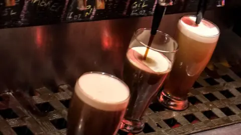 Glasses of house beer at the taps at Le Cheval Blanc