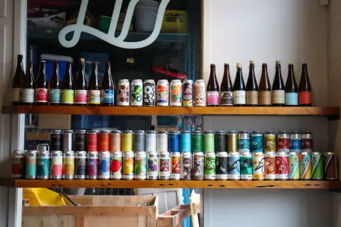 Luppolo cans and bottles on a shelf