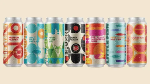 A row of Main St. Brewing cans