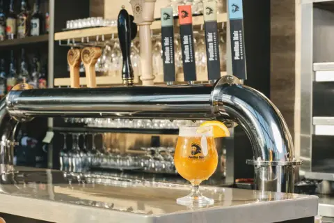 A glass of house beer at the tap counter of the Microbrasserie du Pavillon Noir