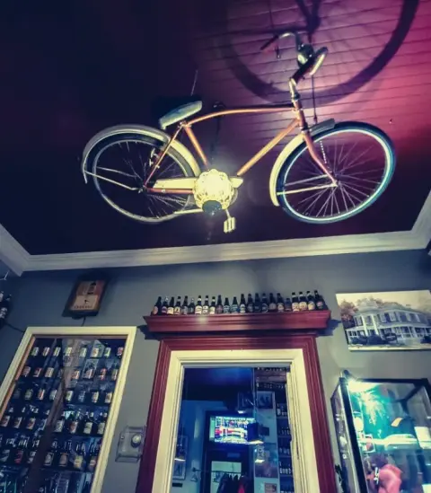 Entrance of the Le Presbytère pub with its wall of beer bottles