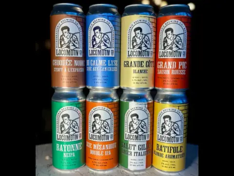 Eight Locomotiv cans with the new labels, including Bayonne NEIPA and Grand Pic saison