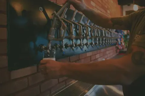 Pouring beer from the row of taps at Wick Station