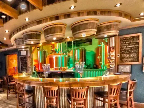 The Nunavut Brewing taproom bar in front of the copper brewhouse