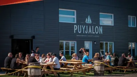 The Puyjalon brewery-distillery building and terrace in Havre-Saint-Pierre