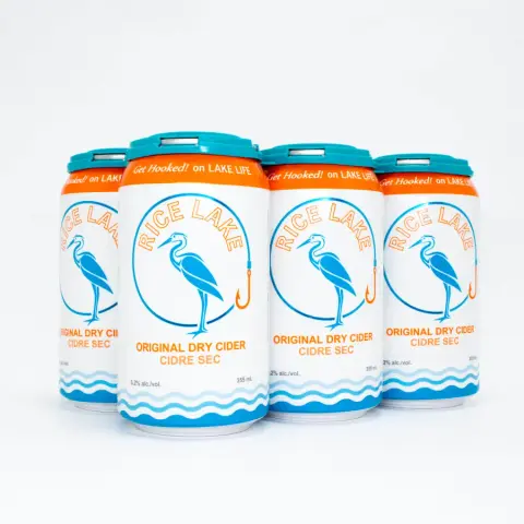 A six pack of Rice Lake Original Dry Cider cans with the heron label