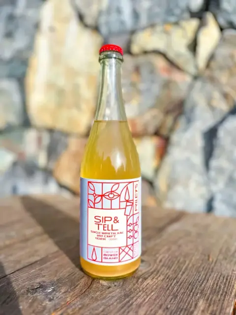 Bottles of Riley's Cidery Sip & Tell McIntosh cider