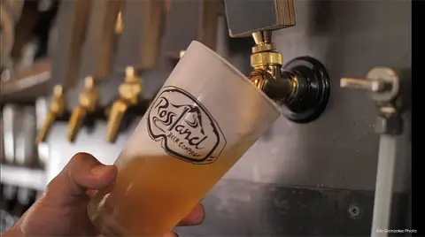 Beer poured from the tap into a Rossland Beer Company glass