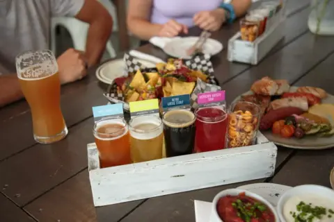 A tasting flight of Rustic Reel beers with food