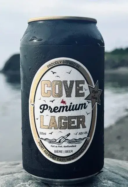 Can of Cove Premium Lager on a rock by the water in Port au Port