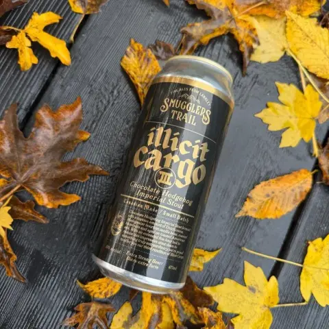 A can of Smugglers Trail Illicit Cargo on autumn leaves