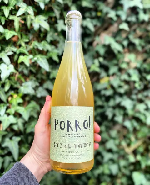 A 750 ml bottle of Porro!, a sidra-style wild ferment cider with pear